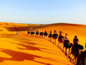 Enjoy Moda Camp Merzouga tours- Camel sunset sunrise Quad Sunboarding ATV